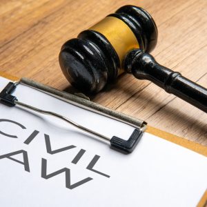 A gavel and a clipboard with the words "Civil Law" written on it. Law concept.